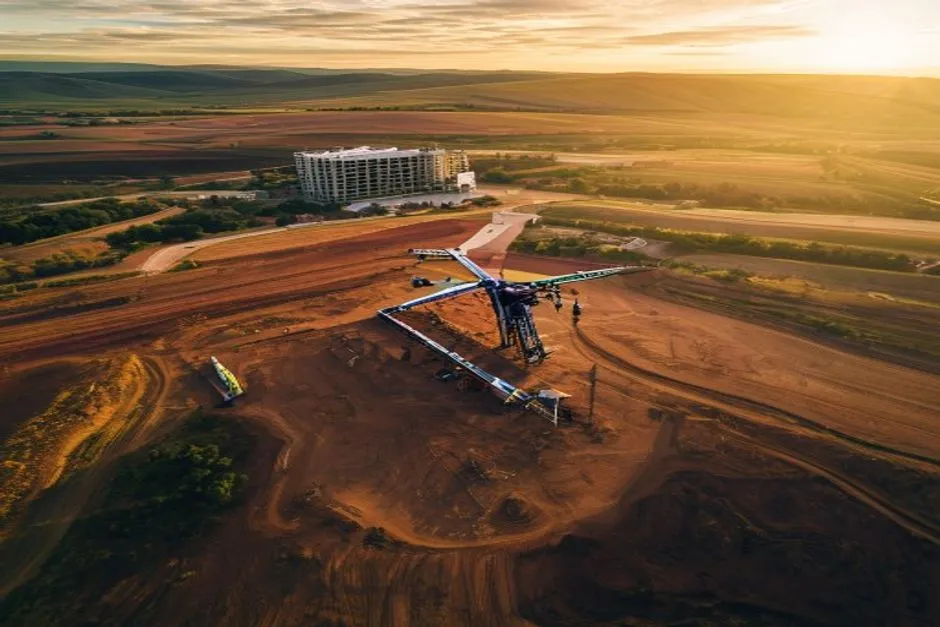 aerial imaging in progress at a construction site in Huntsville, AL with local terrain visible